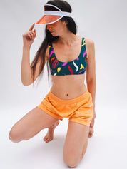 Mannequin portant le short éponge coton léger orange avec la brassière de sport u motif rétro coloré UJO